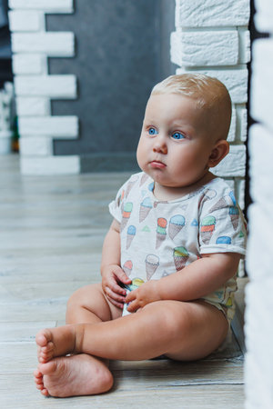 Cute little boy playing at home and laughing. cheerful kid laughs. An emotional childの写真素材