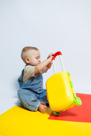 Cute little boy playing with his suitcase. Little boy tourist with suitcase. Travel concept.の写真素材