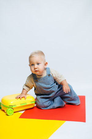 Cute little boy playing with his suitcase. Little boy tourist with suitcase. Travel concept.の写真素材