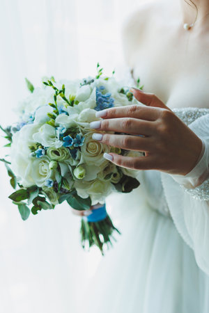 The bride in a white dress holds a bouquet of fresh flowers in her hands. Bride's bouquet.の写真素材
