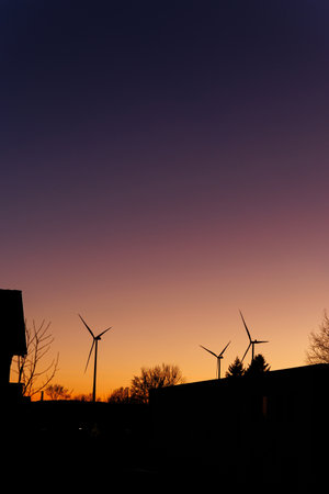 Wind turbine energy production at sunset. Electricity is produced by a wind turbine. Ecological energy productionの写真素材