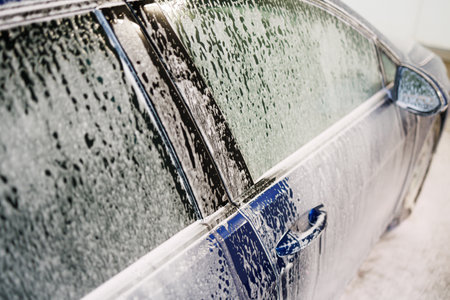 Close-up photo. Car parts with thick foam. Chemicals for washing dirty vehicles.の写真素材