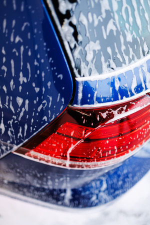 Close-up photo. Car parts with thick foam. Chemicals for washing dirty vehicles.の写真素材