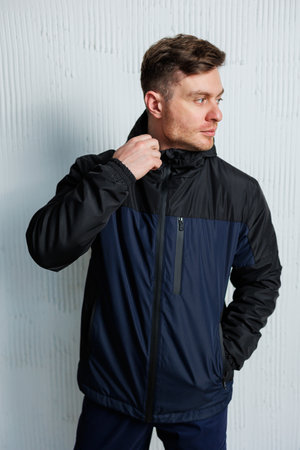 A stylish and fashionable man is dressed in a trendy jacket that is ideal for various outdoor...
