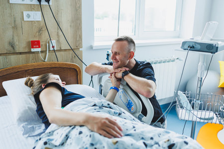 Husband and wife in the delivery room preparing for the birth of a child. The husband supports his wife during labor. The wife gives birth in the presence of her husbandの写真素材