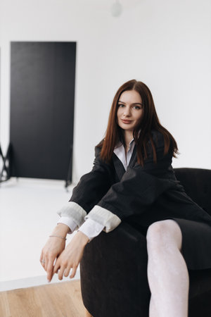 A stylish professional portrait showcasing a fashionable woman in a modern and chic office environmentの写真素材