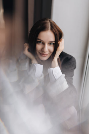 A striking and captivating portrait of a confident woman showcasing her unique style in a vibrant modern settingの写真素材