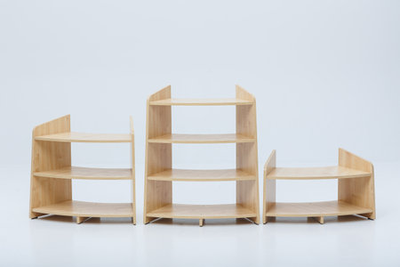 Three beautifully crafted wooden shelves are neatly lined up in a row on a crisp, clean white surface, creating a stunning displayの写真素材