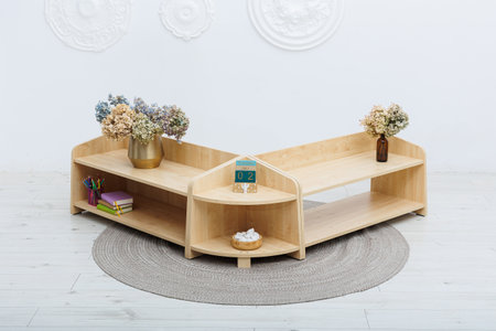 A beautifully crafted wooden shelf that features a lovely vase filled with vibrant flowers elegantly displayed on itの写真素材