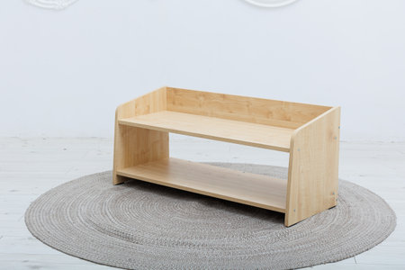 A beautiful wooden shelf is elegantly sitting on top of a round rug, adding a touch of style to the rooms decor and atmosphereの写真素材