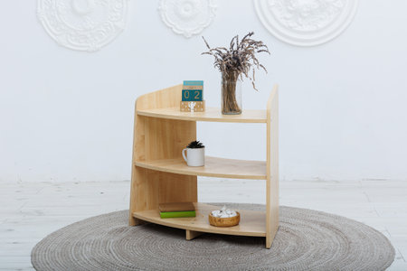 A beautifully crafted wooden shelf that is adorned with a lovely vase of freshly arranged flowers positioned elegantly on itの写真素材