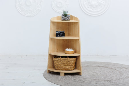 A beautifully crafted wooden shelf that features a stylish basket placed on the bottom shelf, combining functionality with natural aestheticsの写真素材
