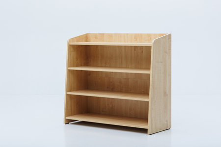 A beautifully crafted wooden shelf holding three distinct shelves set against a clean, white background to enhance its eleganceの写真素材