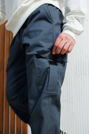 Discover trendy cargo pants that boast a unique texture, complemented by functional pockets to enhance your urban styleの写真素材