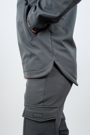 A person is wearing a grey hoodie paired with cargo pants that feature several pockets for convenience and comfortの写真素材