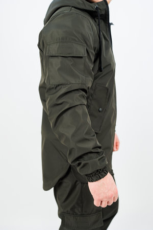 A man dressed in a stylish jacket is wearing a watch on his wrist that catches the eye and...
