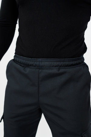 The individual is dressed in a black shirt along with matching black pants, creating a uniform and sleek appearanceの写真素材