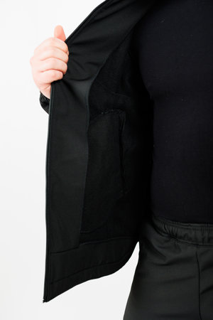 A person is wearing a stylish black jacket featuring a zipper, which enhances its functionality and aesthetic appeal during casual outingsの写真素材