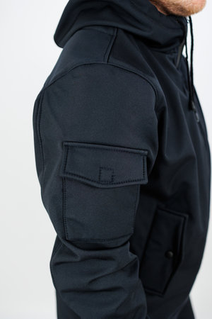 A man is currently wearing a stylish black jacket that features a cozy hood, which adds to its appeal and functionalityの写真素材