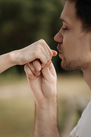 A tender and beautiful moment that truly showcases love through a soft kiss on the hand of a loved oneの写真素材