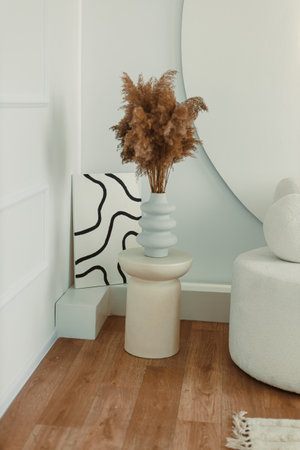 Vase with dried flowers. Dried flowers in a white vase. Interior vase for the room.の写真素材