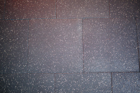 A comprehensive and detailed view of glittering asphalt shingles, perfect for roofing and construction visualsの写真素材