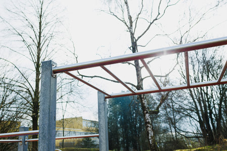 A vibrant and lively view of exercise bars in a beautiful park, creating an inviting outdoor fitness...