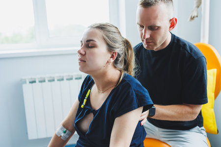 Pregnant woman feels severe pain during childbirth. Caring man helps woman during childbirth and massages her back. Support and love concept.の写真素材