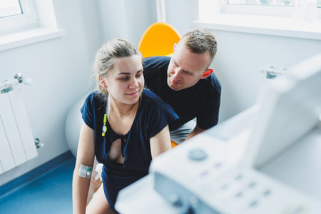 Caring husband holding pregnant wife's hand during childbirth. Supporting husband helping young woman during childbirth. Concept of support and medical care during childbirth.の写真素材