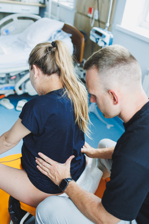 Caring husband holding pregnant wife's hand during childbirth. Supporting husband helping young woman during childbirth. Concept of support and medical care during childbirth.の写真素材