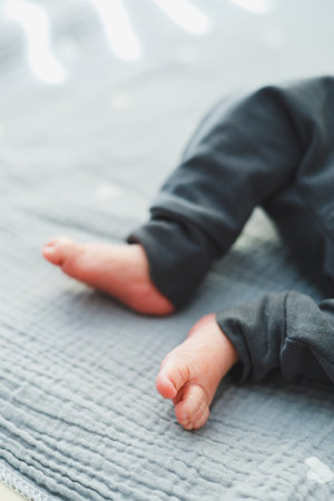 Closeup of cute baby feet resting on a soft gray blanket, symbolizing tranquility and the pure essence of childhood innocenceの写真素材