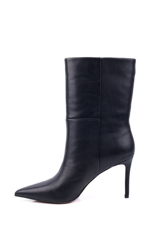 Black leather women's ankle boots with high heels on a white background. Women's stylish autumn shoes. Spring elegant women's boots with heelsの写真素材