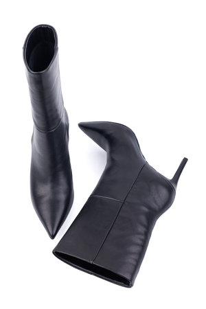 Black leather women's ankle boots with high heels on a white background. Women's stylish autumn shoes. Spring elegant women's boots with heelsの写真素材