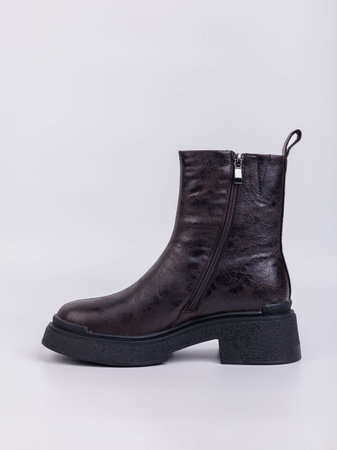 Women's boots on a flat sole made of genuine leather on a white background. Autumn casual women's shoes.の写真素材