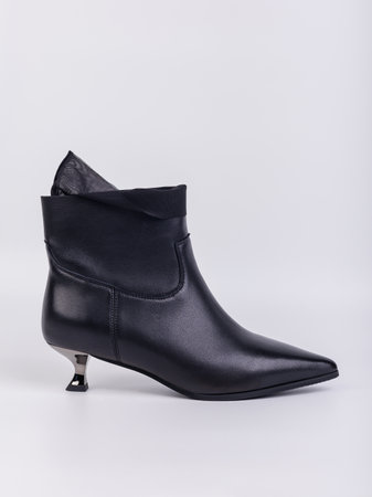 Elegant women's boots with heels made of genuine leather in black with fasteners on a white background. Stylish autumn women's shoes for every dayの写真素材