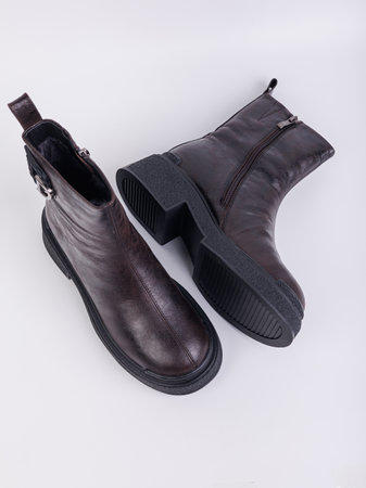 Women's boots on a flat sole made of genuine leather on a white background. Autumn casual women's shoes.の写真素材