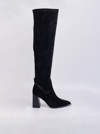 Women's high-heeled suede boots. Elegant black women's boots. Winter elegant women's shoesの写真素材