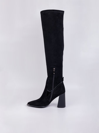 Women's high-heeled suede boots. Elegant black women's boots. Winter elegant women's shoesの写真素材