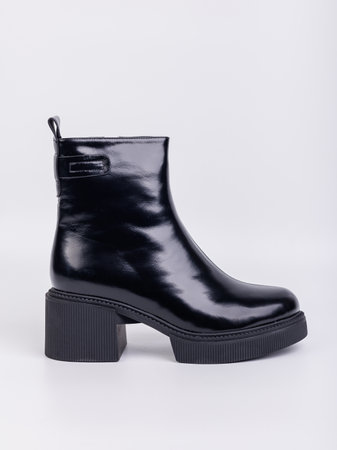Black boots made of leather on a white background. Women's autumn casual shoes. Comfortable boots for women.の写真素材