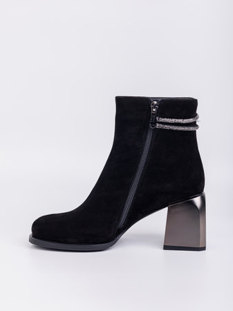 Elegant women's boots with heels made of genuine leather in black with fasteners on a white background. Stylish autumn women's shoes for every dayの写真素材