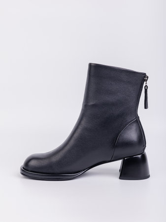 Women's boots with black zippers made of natural leather on a white background. Women's autumn casual shoes. Comfortable boots for women.の写真素材