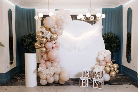 A beautifully arranged balloon backdrop designed specifically for a baby shower, featuring soft...