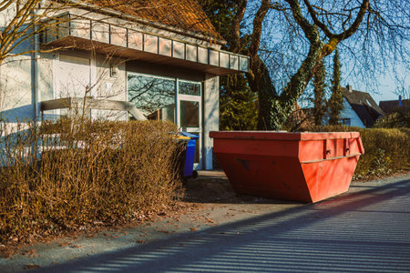 Large metal container for construction waste. Container stands near the house to remove waste after renovation. Removal of construction waste.の写真素材