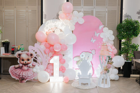 Create a magical celebration with stunning pink and white balloon decorations and charming characters, perfect for a first birthday or a fun gathering to rememberの写真素材