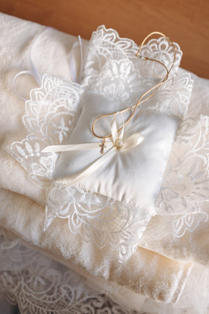 Elegant white lace and satin wedding accessories boast delicate craftsmanship and timeless charm, perfect for brides seeking sophistication for special occasionsの写真素材