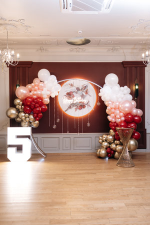 Stunning balloon arch decor featuring gold, red, and white colors, ideal for a birthday party or celebration backdrop. Perfect for creating memorable momentsの写真素材