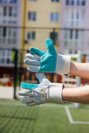 These vibrant goalkeeper gloves are displayed in a sunny outdoor setting, showcasing the ideal gear that ensures both safety and skilled performance in goalkeepingの写真素材