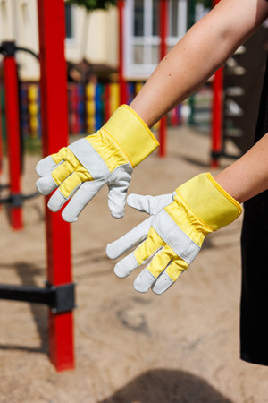These bright yellow gloves are designed for outdoor tasks, offering comfort and a firm grip, making them perfect for gardening, construction, and sandy playgroundsの写真素材