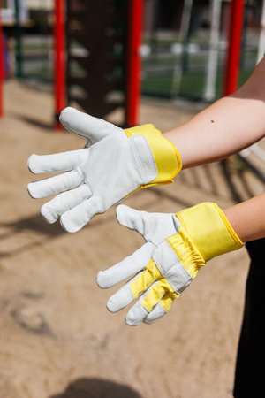 These durable work gloves feature bright yellow cuffs, perfect for outdoor tasks. They provide excellent grip and reliable hand protection for safety and comfortの写真素材