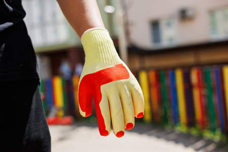 A bright, multicolored glove basking in sunlight, ideal for outdoor tasks. It combines utility and style, making it essential for enthusiastsの写真素材